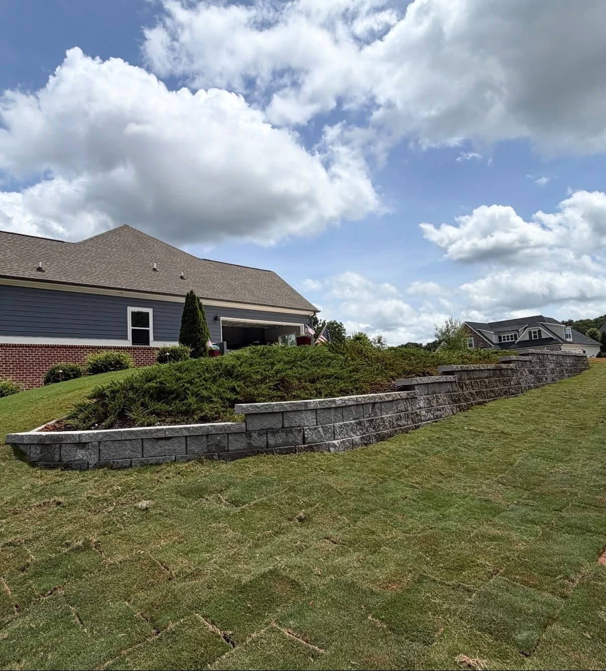 Finished stepped block retaining wall with new sod by Green Wave